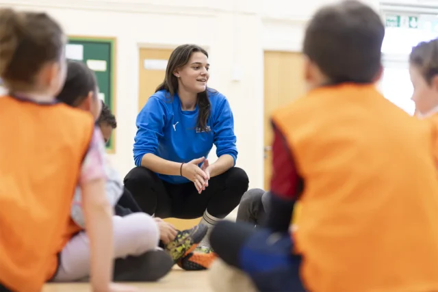coach coaching group of children