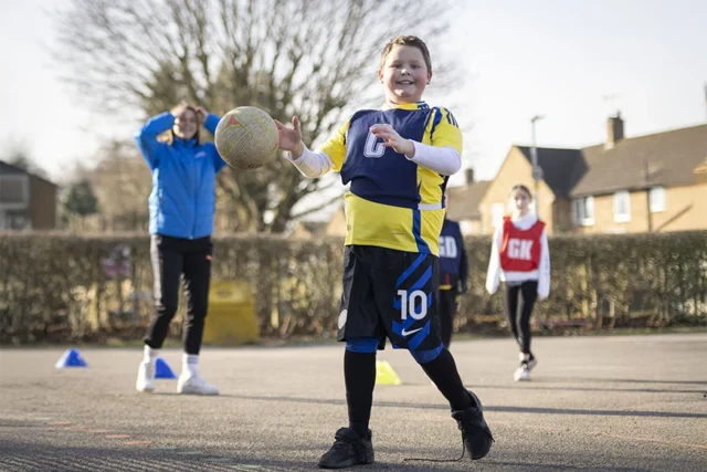 Primary school pupil practising ball skills during a structured PE coaching session with Game On Sports Coaching